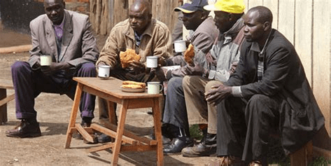 Kenyan men drink tea while sitting outside an eating joint at a trading centre in West Pokot County on July 26, 2015